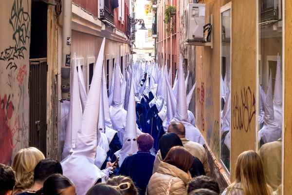 Hooded men in the streets of malaga Spain thumbnail