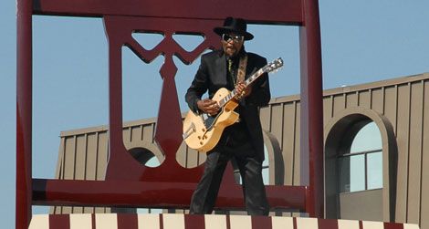 Go-go legend Chuck Brown poses on the Big Chair, a downtown Anacostia landmark.