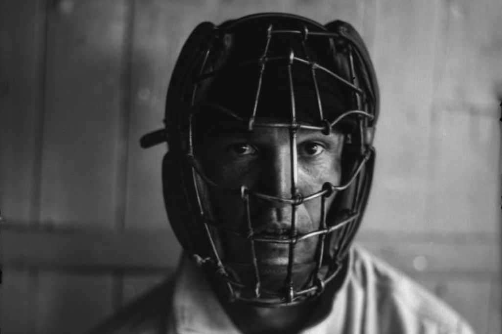 A player wearing an old-fashioned catcher's mask