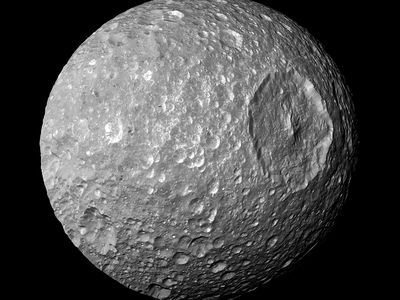 The giant Herschel Crater gives Saturn’s moon Mimas an ominous look.