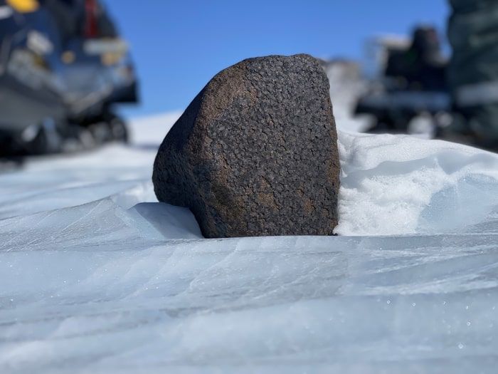black meteorite in snow