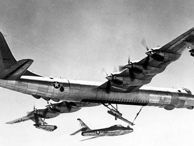 An F-84 experimental parasite fighter attaches to a B-36