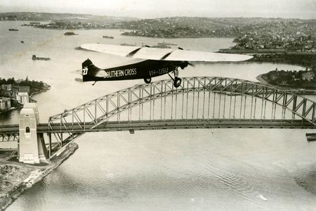 After his celebrated trans-Pacific flight, Charles Kingsford Smith flies the famed Southern Cross over Sydney Harbor.