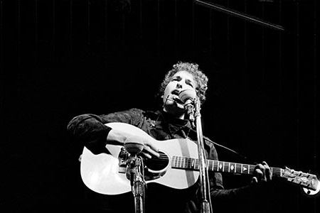 Bob Dylan at the Newport Folk Festival in 1964 where he was an acoustic icon. The following year, he went electric.