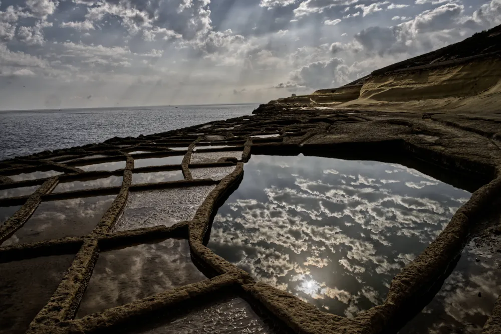 This abandoned salina was captured shortly after sunrise in Xwejni, a remote coastal town in Gozo. Traditional salt producing salina’s (salt pans) in the mediterranean have been on the decline since the 1950’s for a variety of reasons related to migration, economics, and the development of land for industrial, urbanization and tourism projects. Out of approximately 170 salina’s in the mediterranean region approximately 64 are inactive or abandoned.