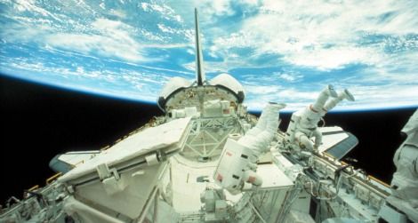 Astronauts float in zero gravity outside the Challenger space shuttle in 1984.