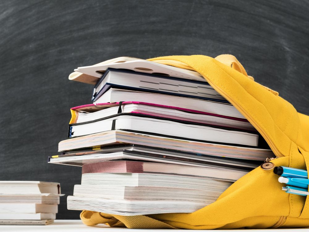 yellow backpack stuffed with books