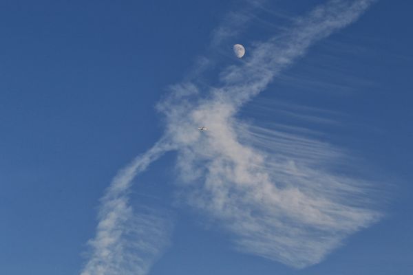 An Angel cloud with an almost full moon and a jetliner thumbnail