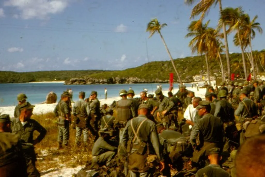 “Sweaty troops on the beach prepare to move out.”
