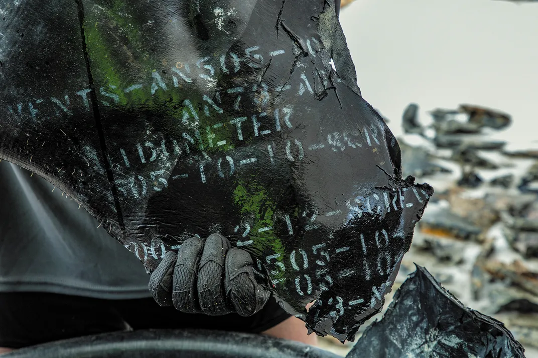 Pieces of the plane’s rubber fuel bladder, with white stenciled markings indicating serial numbers still clear and legible, recently brought up from the ocean floor.