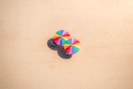 Colorful umbrellas protect beachgoers from the glaring sun on a day when most seemingly opted to stay somewhere cooler.