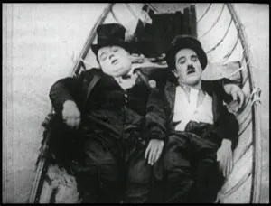 Arbuckle and Charlie Chaplin in The Rounders.
