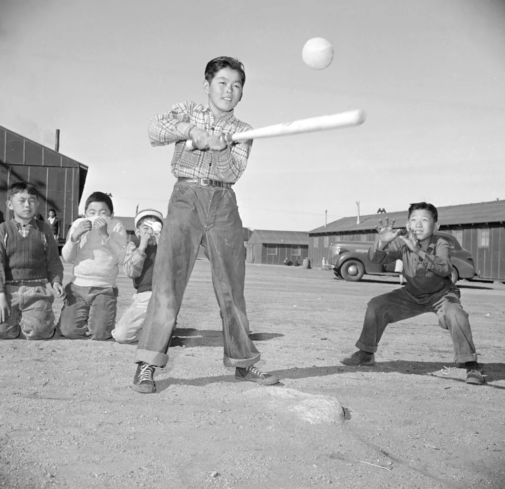 boys at Manzanar enjoy a game of softball at recess