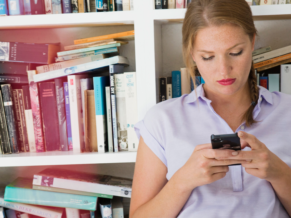 Woman Texting in Library