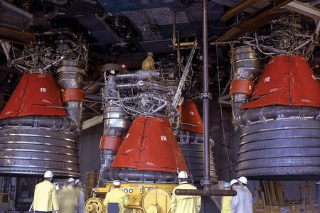 In April 1965, engineers install five 1.5-million-pound-thrust F-1 rocket engines on a Saturn V stage for a static test.