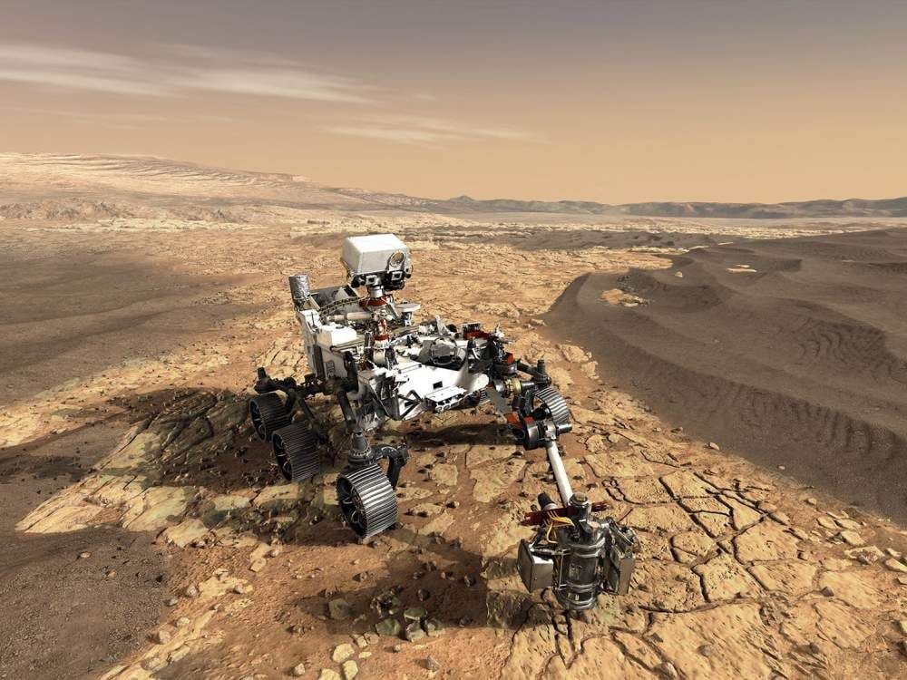 Artist’s conception of the Perseverance rover sampling rocks on the floor of Jezero crater. The rover also carries the Ingenuity helicopter (not shown) that can fly in advance of the rover and scout out high priority rocks and outcrops for the rover to visit. (NASA)