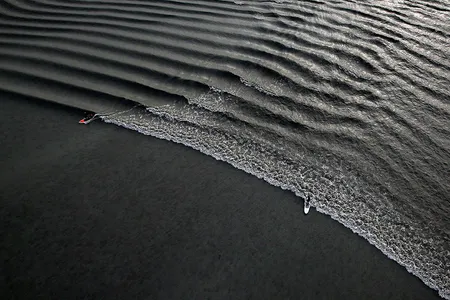 Surfers ride the bore tide at Turnagain Arm.