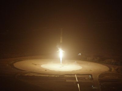 The first stage of a Falcon 9 rocket fires its engine before landing back at Cape Canaveral, December 21, 2015.