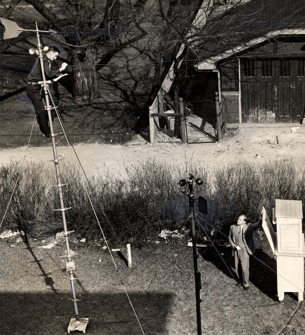 Louis DePas checks wind vane readings at the University of Chicago while Horace Byers, on the ground, corroborates the measurements on an automatic recorder.