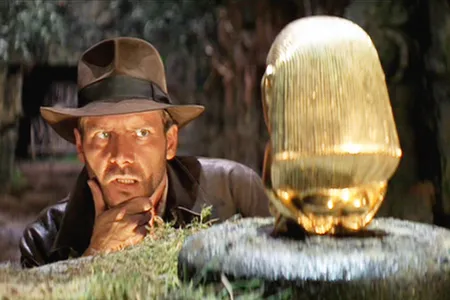 Harrison Ford as Indiana Jones, sizing up the idol, in the opening scene of Raiders of the Lost Ark