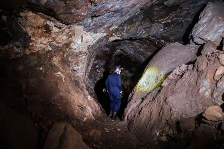 Paleontologist Lee Berger, who led the new research, walks in the Rising Star cave system in South Africa, where the possible burial sites were uncovered.