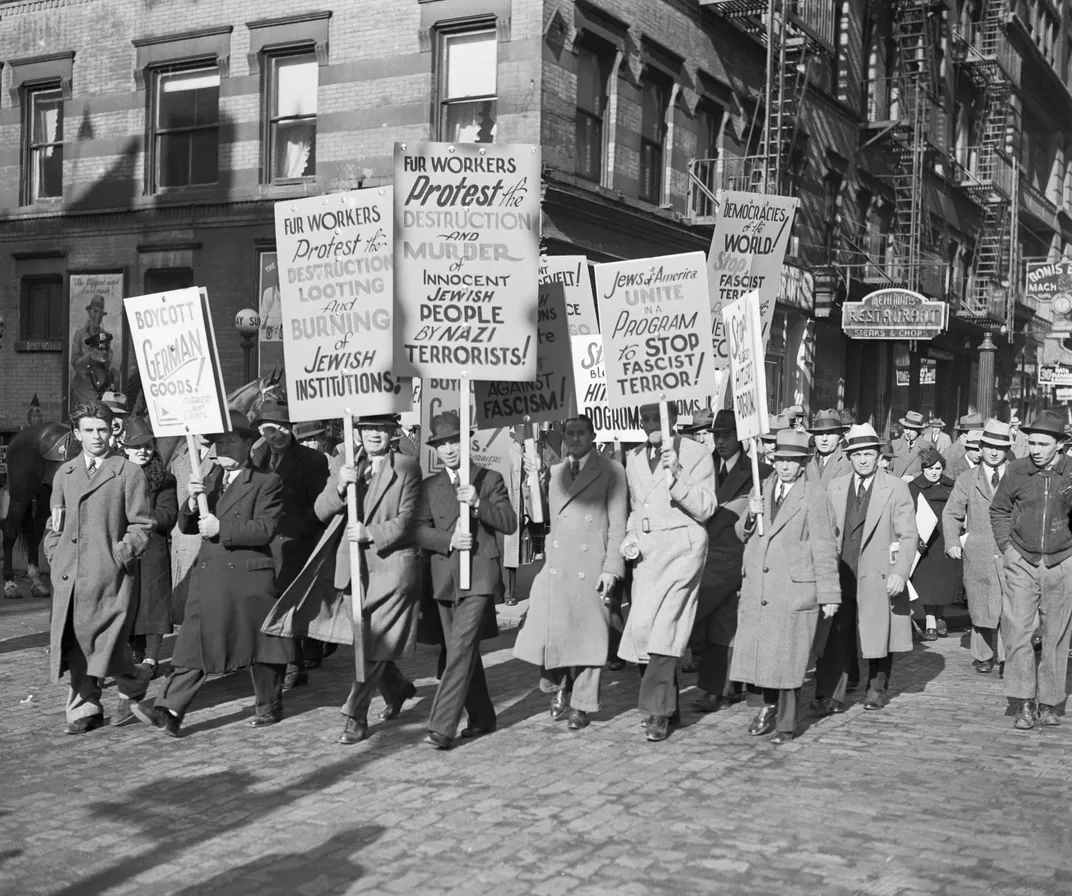 Protesters march in a November 1938 demonstration calling for a boycott of German-produced products.