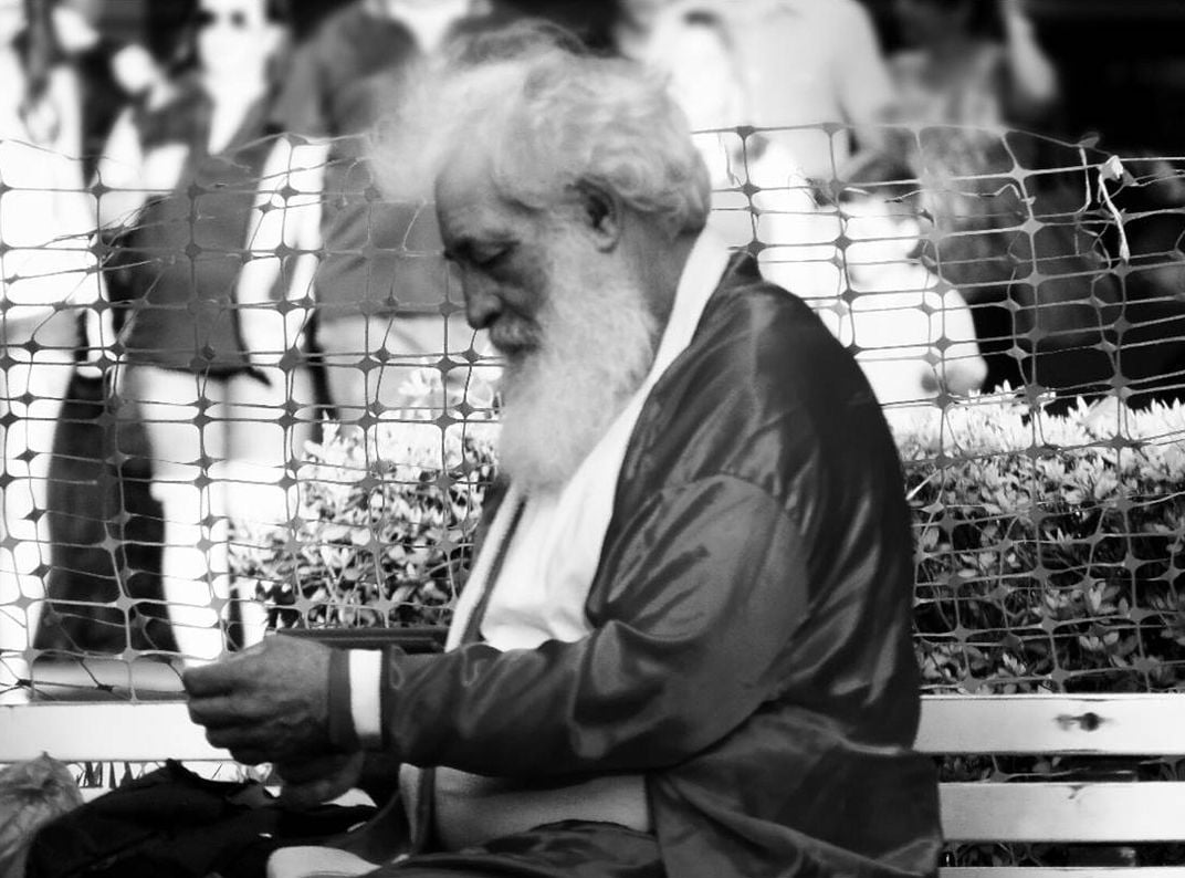 A black and white photo of Santa Claus sitting down