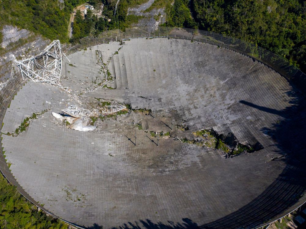This aerial view shows the damage at the Arecibo Observatory after one of the main cables holding the receiver broke in Arecibo, Puerto Rico, on December 1, 2020.