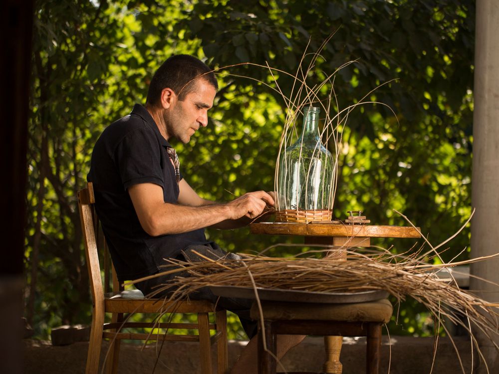 Master basket weaver Arthur Petrosyan sits and works on a project. (Photo by Narek Harutyunyan, My Armenia Program)