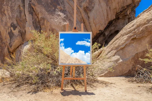 A Reflected View of the Mountains and Sky In A Mirror on an Easel thumbnail
