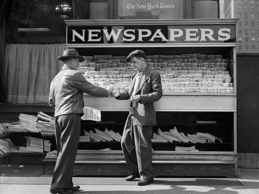 Man buying newspaper in NYC