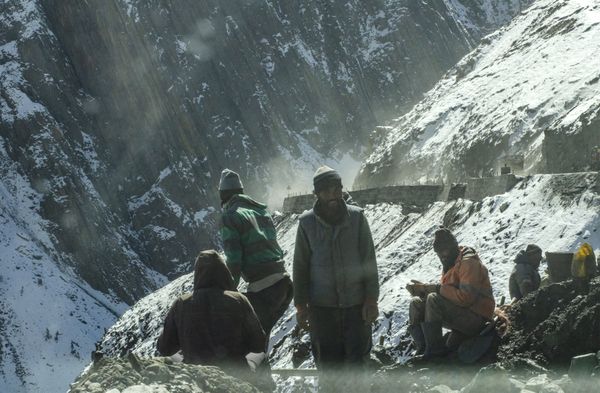 Men at work, resting from the cold weather in Drass, India thumbnail