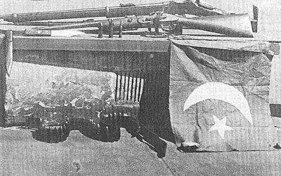 The Turkish flag flown, and rifles used, by Gool Mohammed and Mullah Abdullah during the Battle of Broken Hill, January 1, 1915.