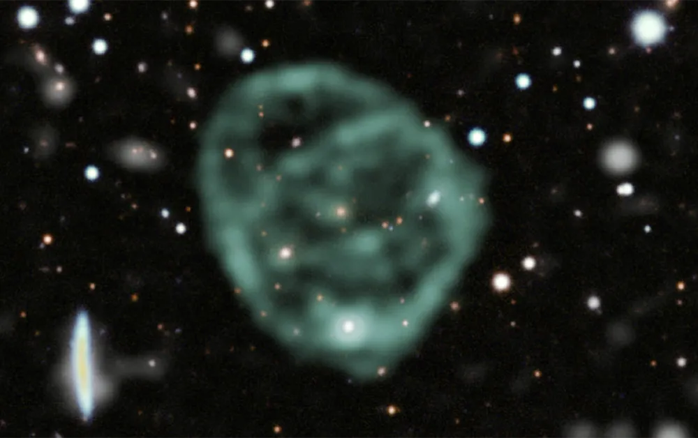 A blurry light-green circle surrounded by stars in space