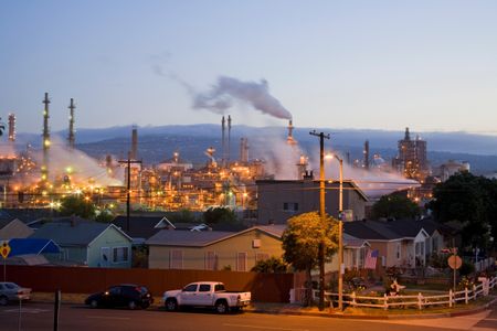 Homes next to oil refinery in Los Angeles' Wilmington neighborhood. Wilmington has one the highest risks of cancer due to air pollution from the Port of Los Angeles at Long Beach and several oil refineries in the vicinity. The neighborhood is more than 80 percent Hispanic or Latino.