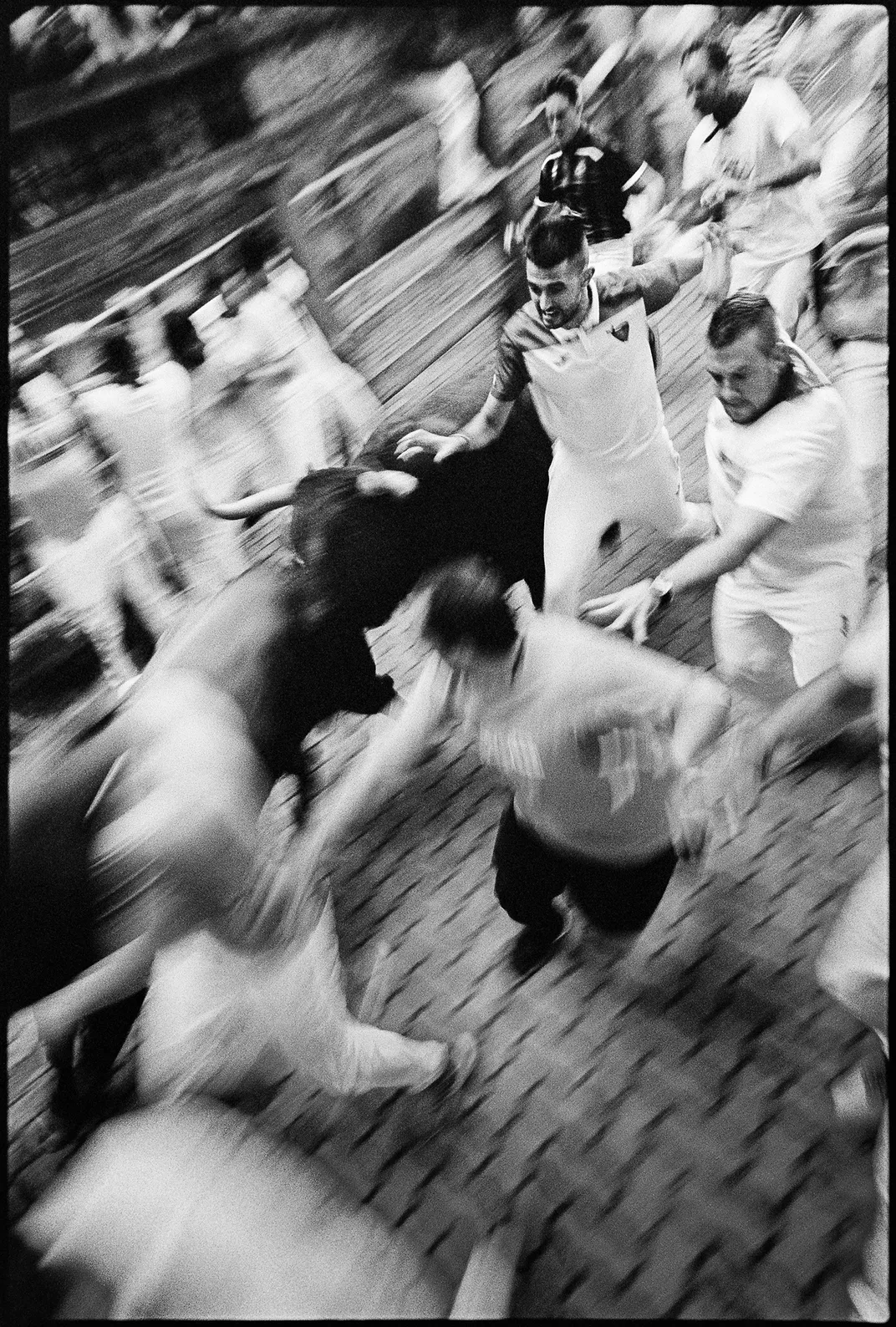 Participants in the daily running of the bulls, or encierro, scramble to stay clear of the animals as they reach the Plaza de Toros, site of the evening’s bullfights.