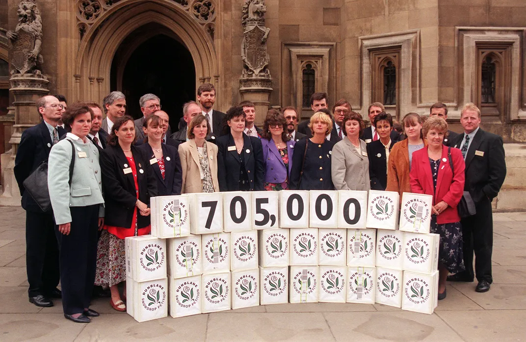 Snowdrop Campaigners standing in front of signed petitions