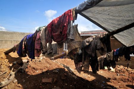 Clothes of genocide victims whose bodies were recently exhumed hang outside at the site of the mass grave in Gasabo district, near the capital Kigali, in Rwanda 