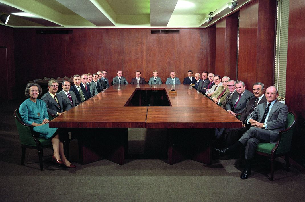 Katharine Graham, publisher of the Washington Post​​​​​​​, sits at the far left of a table otherwise occupied by men