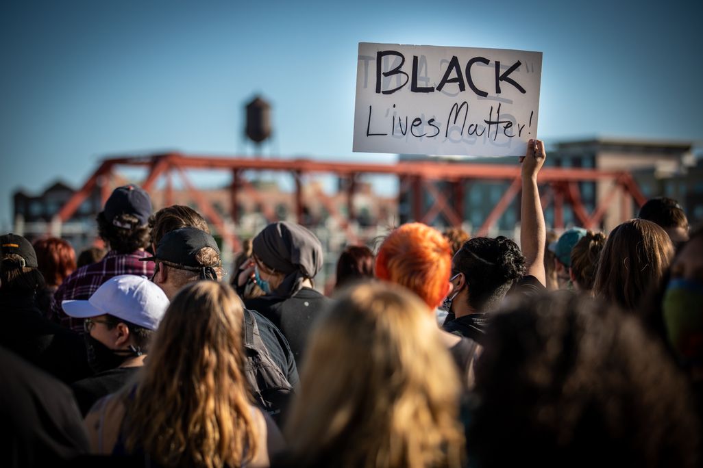 Group of protesters during black lives matter marches holding a black lives matter sign