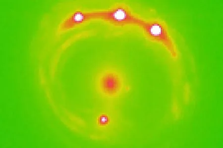 Researchers estimate more than a trillion planets could exist in the elliptical galaxy at the center of this image.