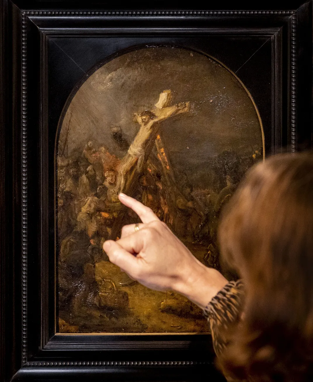 A visitor looks at The Creation of Jesus on the Cross by Rembrandt