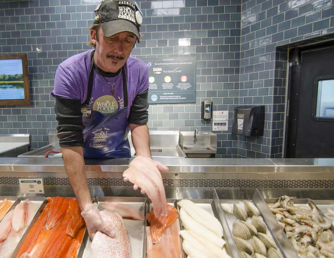 Worker at Whole Foods seafood counter