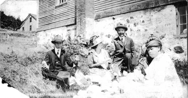 Alfred Nicholls (third from left, holding a Cornish pasty) and his family enjoy a picnic in Central.