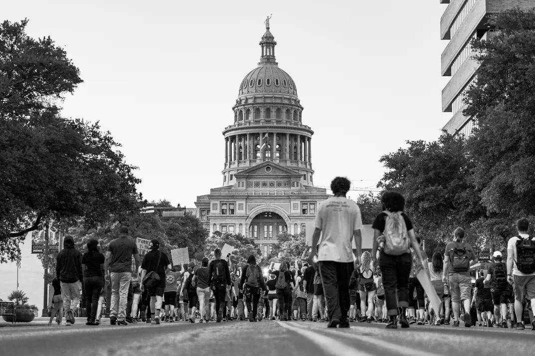 A large group of Black Lives Matter demonstrators peacefully marches down Congress Avenue toward the Texas Capitol building.