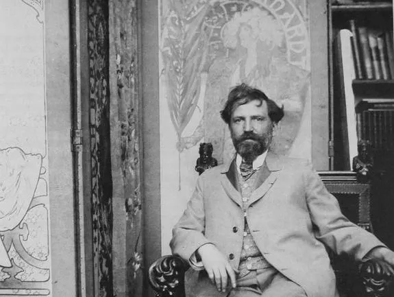 Alphonse Mucha in front of his first poster for Sarah Bernhardt