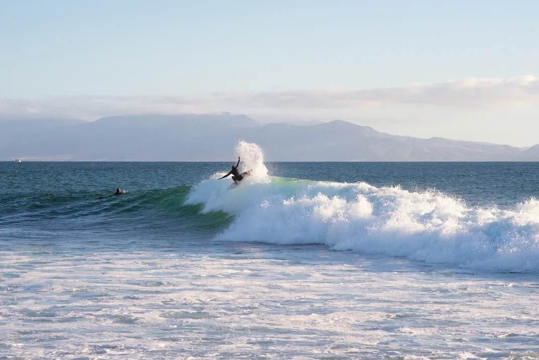 a surfer at the top of a wave