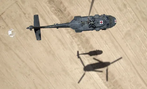 One helicopter helps another in Iraq.