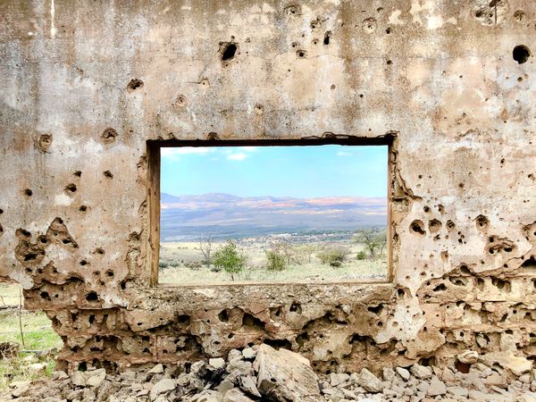 Syrian hillside through the ruined window of an elementary school in Ein Fit thumbnail