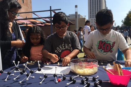 Children participate in a hands-on science activity with the Smithsonian Latino Center for a Dia del Niño festival hosted by LA Plaza de Cultura y Arte in Los Angeles, California. (Smithsonian Latino Center)
